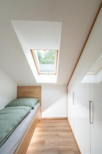 una camera con letto e lucernario di Apartmán Malá Morávka - DZ RENT a Dolní Moravice