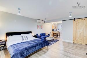 a bedroom with a bed and a couch and a sliding door at The Moose #9 - Brand New Luxe Modern loft with Free Parking, King Bed & Fast WiFi in Memphis