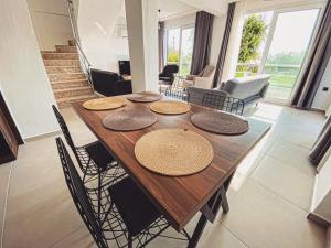 a wooden table with chairs and a dining room at AirPort villa kayacık in Dalaman