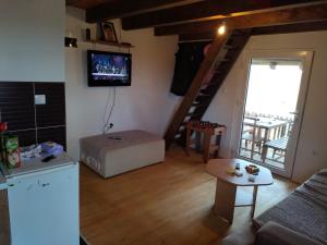 a living room with a couch and a stair case at Vikendica Varosiste Rogatica in Rogatica