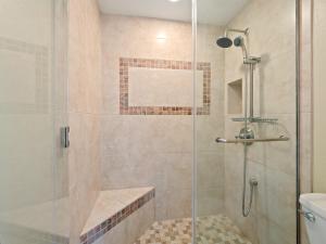 a bathroom with a shower with a glass door at CountryClub Villas Ocean & Golf Views No Stairs in Kailua-Kona