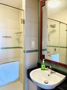 a bathroom with a sink and a mirror and a tub at Stunning 2 Bed Room Unit with Ocean View in Mariakani