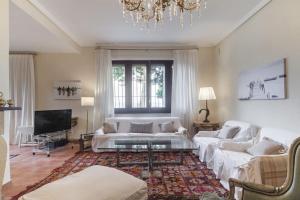a living room with white furniture and a chandelier at Luxury Villa in Alicante in Alicante