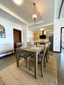 a kitchen and dining room with a table and chairs at Stunning 2 Bed Room Unit with Ocean View in Mariakani