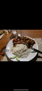 a plate of food on a table with rice at Surangi in Kosgoda
