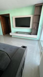 a living room with a flat screen tv and a couch at Apartamento Amoblado Barranquilla San Jose in Barranquilla