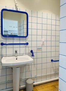 uma casa de banho com um lavatório e um espelho em Superbe appartement à deux pas de la plage! em Villers-sur-Mer