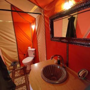 Łazienka z umywalką i toaletą w namiocie w obiekcie Sahara Safari Camp w mieście Merzouga