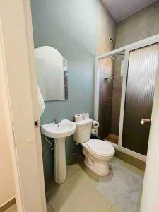 a bathroom with a toilet and a sink at Casa privada, amplia y moderna. in Catacamas