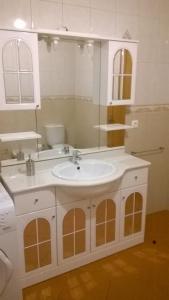 a bathroom with a sink and a mirror at Buganvilias House in Praia de Mira