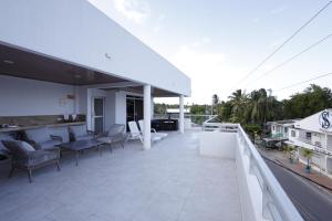 a balcony with chairs and tables on a building at Alka's Paradise Guest House and Lodging in San Andrés