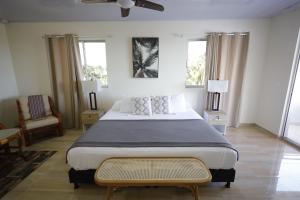 a bedroom with a large bed and two windows at Alka's Paradise Guest House and Lodging in San Andrés +105 photos