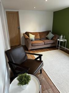 a living room with a couch and a table at Entire Apartment with super king size bed close to Town Centre in Colchester