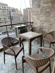 a patio with tables and chairs on a balcony at sfenx abartment hotel in Cairo