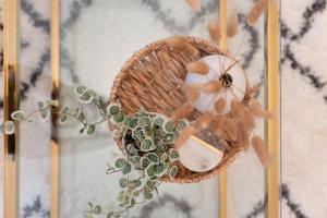 a wicker basket with a plant on a wall at Stunning Large 4 Bedroom Victorian Home London in London