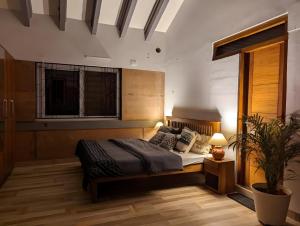 a bedroom with a bed and a potted plant at Red Rock Villa, Virajpet, Coorg in Virajpet