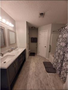 a bathroom with a sink and a tub at Bedroom Four minutes from beach in Pensacola