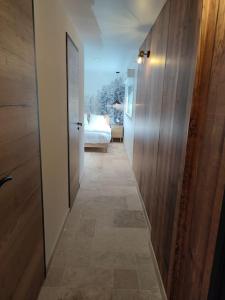 a hallway with a room with a bed and a door at Charmante maison au calme in Verdun-sur-Garonne