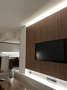 a large flat screen tv on a wall in a living room at Maison 49 Luxury Stay in Patra