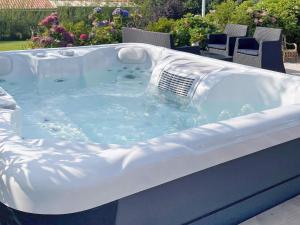 a jacuzzi tub with a grill in a yard at Holiday home Struer XI in Struer