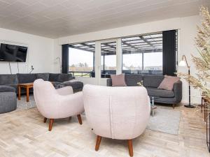a living room with couches and chairs and a tv at 4 star holiday home in Harboøre-By Traum in Harboør