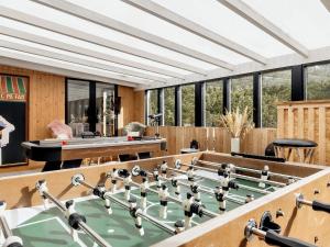 a room with a pool table and ping pong tables at Holiday home Oksbøl XII in Oksbøl
