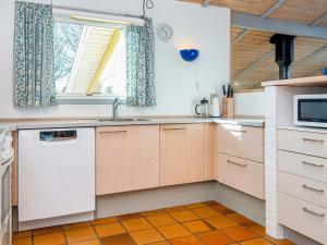 a kitchen with a sink and a microwave at 6 person holiday home in Hemmet in Hemmet