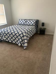 a bedroom with a bed and a table in it at Blessing Home IN in Indianapolis