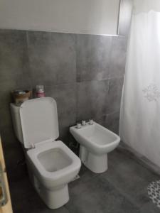 a bathroom with a toilet and a sink at Las Verbenas in San Rafael