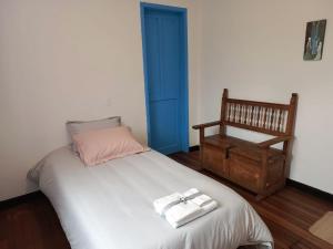 a bedroom with a bed with two towels on it at Casa-Arbol in Bogotá