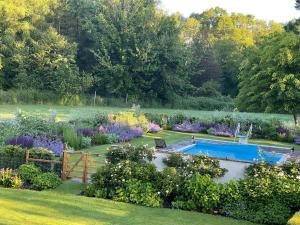 a garden with a swimming pool and flowers at Isle Hill in Newbury