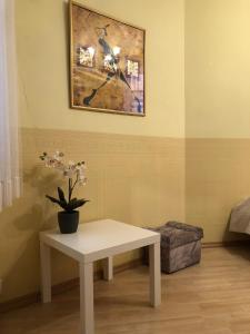 een witte tafel met een potplant op een muur bij Riga Central District, Тихий Центр города, всё под боком, удобно in Rīga
