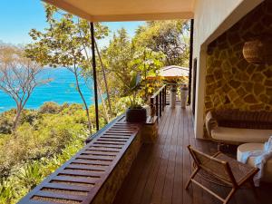 a balcony of a house with a view of the ocean at Tinamaste in Uvita