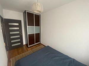 a bedroom with a bed and a closet at Apartament Świder in Otwock
