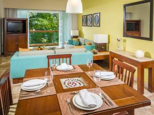 a living room with a table and a couch at Vidanta Riviera Maya - Mayan Palace, Grand Mayan in Puerto Morelos