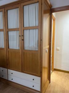 a large closet with wooden doors and windows at Casa Marilu Sallent in Sallent de Gállego +33 photos