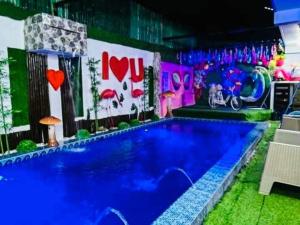 a large swimming pool in a room with a sign at Sharon’s Private Pool Villa in Mandaue City