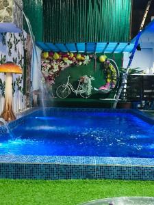 a swimming pool with a water slide and a bike in the water at Sharon’s Private Pool Villa in Mandaue City