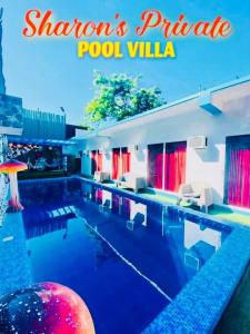 a swimming pool with chairs and a pool villa at Sharon’s Private Pool Villa in Mandaue City