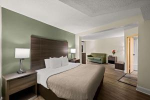 a hotel room with a bed and a couch at Quality Inn & Suites North Little Rock in North Little Rock