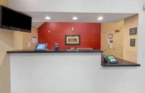 a waiting room with two laptops on a counter at Extended Stay America Suites - Raleigh - Cary - Harrison Ave in Cary