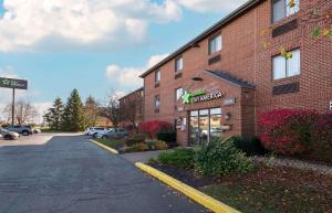 a brick building with a sign for a restaurant at Extended Stay America Suites - Fort Wayne - North in Fort Wayne