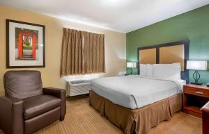 a hotel room with a bed and a chair at Extended Stay America Suites - Fort Wayne - North in Fort Wayne