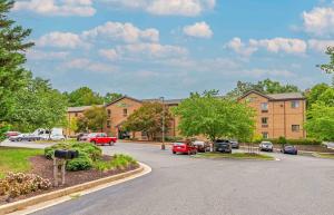 a parking lot with cars parked in front of a building at Extended Stay America Select Suites - Richmond - Innsbrook in Richmond