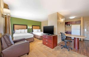 a hotel room with two beds and a desk at Extended Stay America Suites - Columbus - Polaris in Columbus