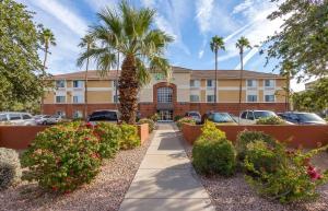 a building with a palm tree in a parking lot at Extended Stay America Suites - Phoenix - Biltmore in Phoenix