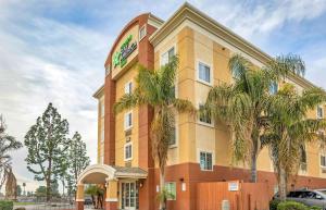 a hotel with palm trees in front of it at Extended Stay America Suites - Bakersfield - Chester Lane in Bakersfield