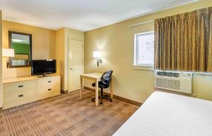 a hotel room with a desk and a television at Extended Stay America Suites - Destin - US 98 - Emerald Coast Pkwy in Destin