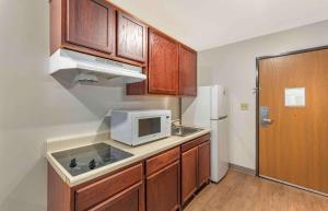 a kitchen with a sink and a microwave at Extended Stay America Select Suites - Little Rock - Southwest in Little Rock