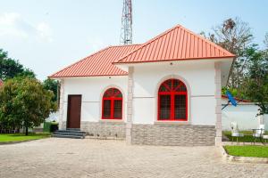 a small white house with a red roof at 1 Bedroom Bungalow in Alalubosa GRA in Ibadan